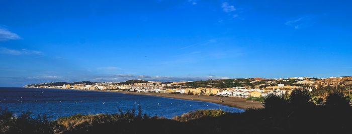 Scenic view of sea against blue sky