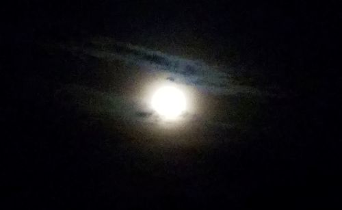 Low angle view of moon in dark sky