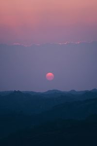 Scenic view of silhouette mountains against sky during sunset