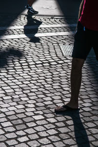 Low section of person walking on sidewalk