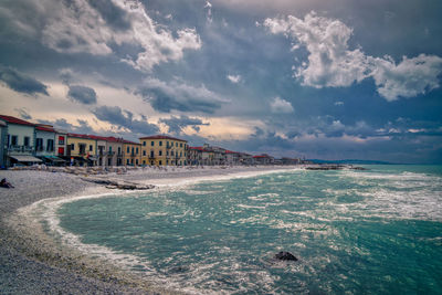 Scenic view of beach against sky in city