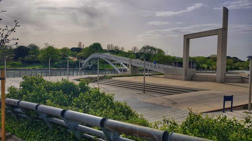 View of bridge by building against sky