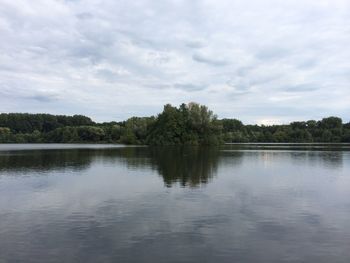 Scenic view of lake against cloudy sky