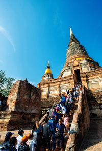 Group of people in temple against sky