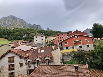 Houses in town against sky