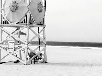 Close-up of lifeguard hut on beach against clear sky