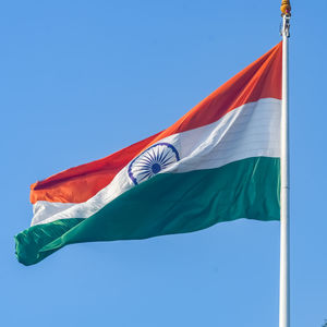 India flag flying high at connaught place with pride in blue sky, india flag fluttering, indian flag