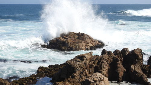 Waves breaking on rocks at shore