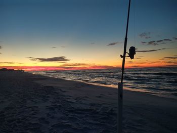 Scenic view of beach against sky during sunset