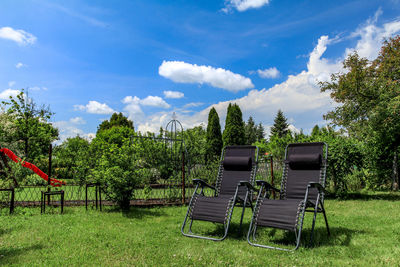 Empty chairs on field