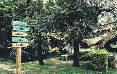 Road sign by trees