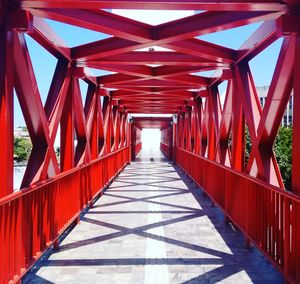 Empty red bridge against sky