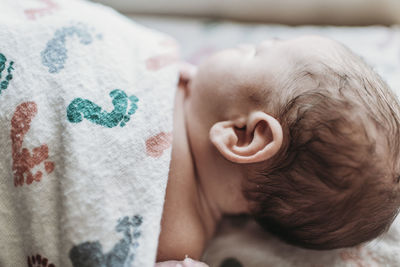 Close up detail of newborn boy ear in hospital