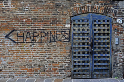 Closed window on brick wall of building