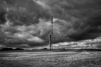 Windmill on field against sky