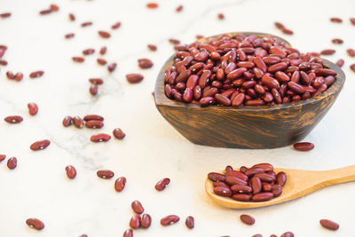 High angle view of kidney beans in heart shape bowl over white background