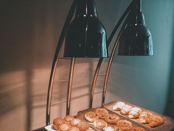 Sweet food in trays against wall