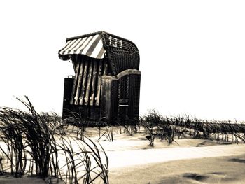 Lifeguard hut in city against clear sky