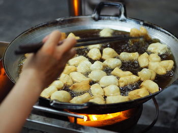 Cropped hand of person preparing food for sale