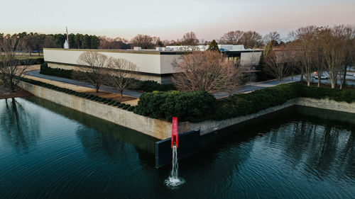 High angle view of swimming pool by river against sky