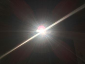 Low angle view of sun shining in sky