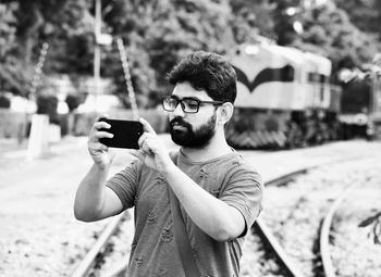 Portrait of young man photographing