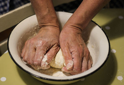 High angle view of person preparing food in cooking pan