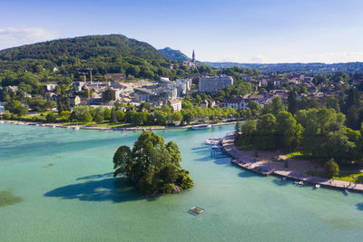 High angle view of townscape by sea against sky