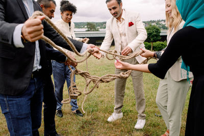 Rear view of people holding hands