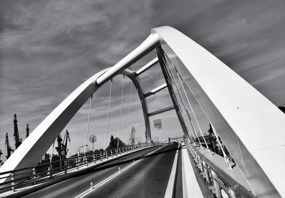 Bridge against cloudy sky