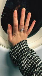 Close-up of woman hand on mirror