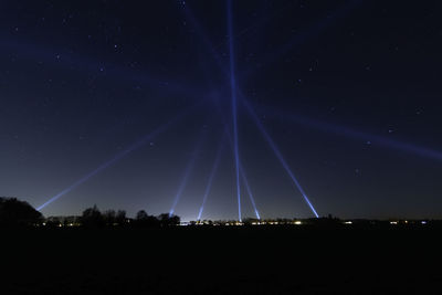 Low angle view of illuminated sky at night