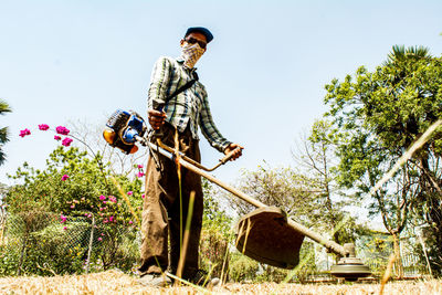 Low angle view of man working on field