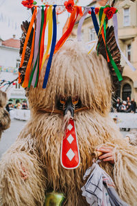 Close-up of mask hanging in traditional clothing