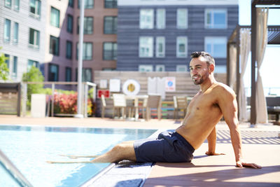 A man relaxes by the pool.