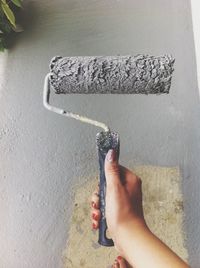 Young woman holding paint roller