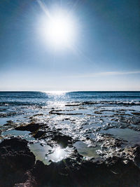 Scenic view of sea against sky on sunny day