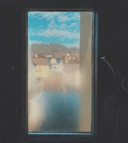 Close-up of glass window against building in city