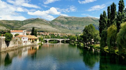 Scenic view of river with mountains in background