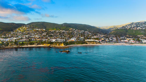 Scenic view of sea and mountains against sky