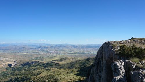 Scenic view of mountains against clear blue sky