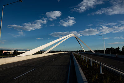 View of bridge in city against blue sky