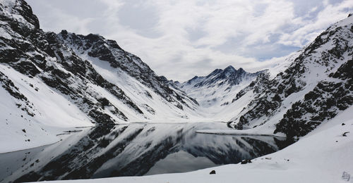 Scenic view of snow covered mountains against sky