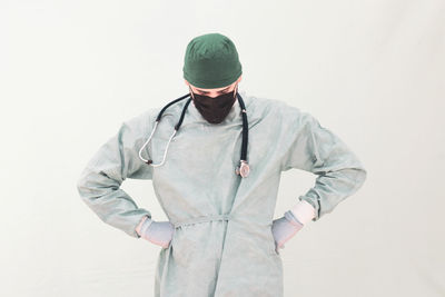 Man wearing hat standing against white background