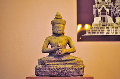 Close-up of buddha statue against building