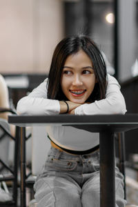 Portrait of young woman looking away