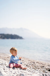 Boy sitting on beach