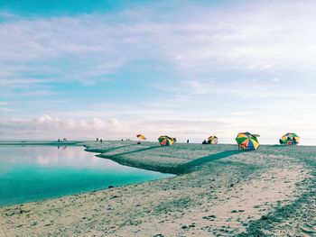 Umbrellas at beach against sky