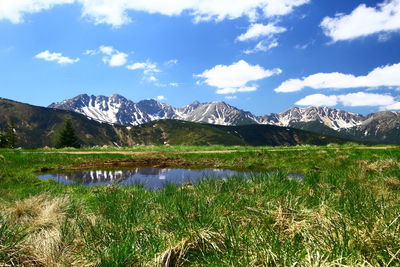 Scenic view of lake and mountains against sky