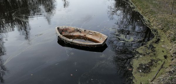 High angle view of abandoned boat floating on lake, 